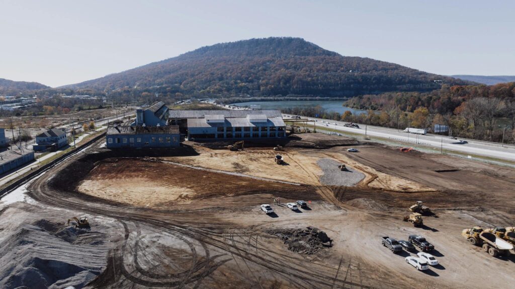 Aerial view of a construction site in Chattanooga, Tennessee with Lookout Mountain in the background.